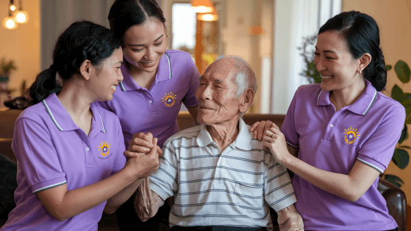 a-photo-of-staff-_holding-hands-with-elderly-man-at-sunrsie-aged-care_v2_600px.png